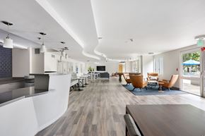 Los Angeles apartment for rent - A modern office space with a long wooden table and chairs.