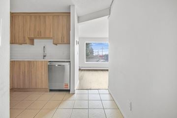 Calgary apartment for rent - A kitchen with wooden cabinets and a fridge.