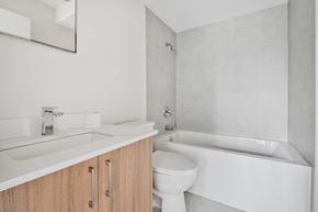 Calgary apartment for rent - A white bathroom with a sink, toilet, and bathtub.