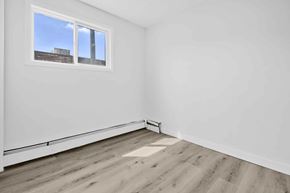Calgary apartment for rent - A room with a window and wooden flooring.
