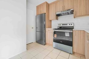 Calgary apartment for rent - A kitchen with a refrigerator, oven, and cabinets.