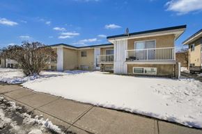 Calgary apartment for rent - A row of houses with snow on the ground.