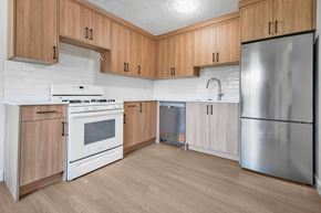 Calgary apartment for rent - A kitchen with wooden cabinets and stainless steel appliances.