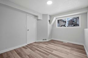 Calgary apartment for rent - A room with a wooden floor and a window.