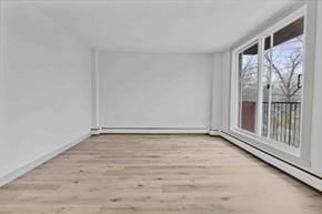 Calgary apartment for rent - A room with a window and wooden flooring.