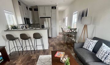 Flagstaff apartment for rent - a living room and kitchen with a couch and a table