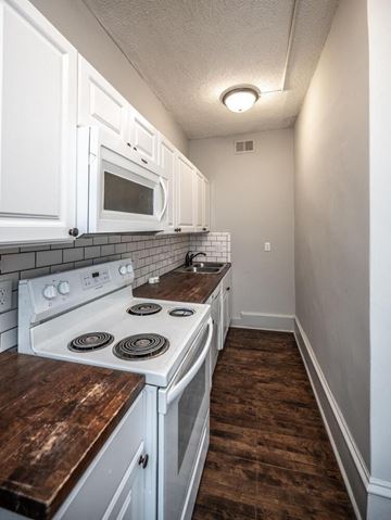 Minneapolis apartment for rent - a kitchen with white appliances and white cabinets