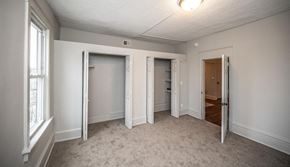Minneapolis apartment for rent - a bedroom with three closets and a door to the bathroom