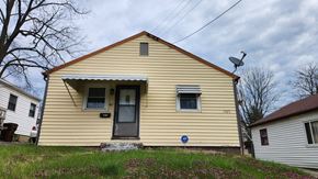 Cincinnati house for rent - a yellow house with a satellite dish on the roof