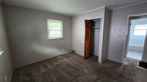 Cincinnati house for rent - a bedroom with a door to a closet and a window
