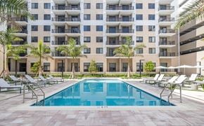 Miami apartment for rent - a swimming pool in front of an apartment building