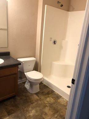 Marshall apartment for rent - A white toilet sits in a bathroom next to a sink.