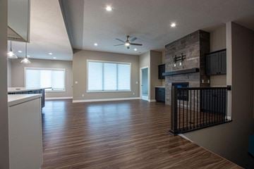 Roca house for rent - a living room with a fireplace and a wooden floor