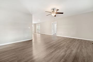 Richlands house for rent - a living room with white walls and a ceiling fan