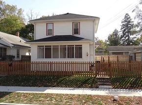 South Bend apartment for rent - A white house with a brown fence in front.