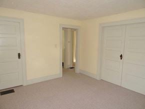 South Bend apartment for rent - A room with two doors and a carpeted floor.