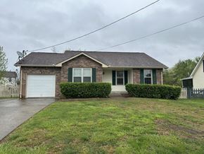 Clarksville house for rent - A house with a grey roof and green shutters.
