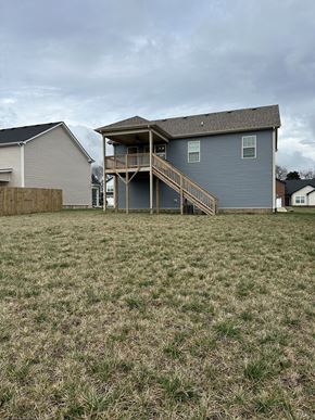 Clarksville house for rent - a blue house with a deck on top of a grass yard