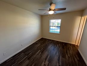 Arlington house for rent - A room with a ceiling fan and a window showing a view of a pool.