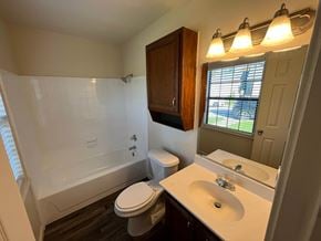 Arlington house for rent - A bathroom with a toilet, sink, and tub.