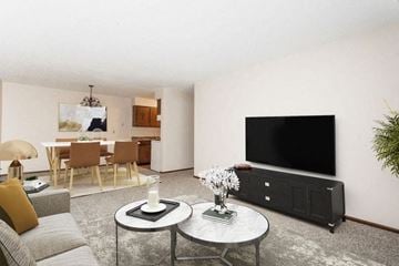 Hudson apartment for rent - a living room with a television and a table