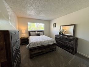 Tucson apartment for rent - a bedroom with a bed and dressers and a window