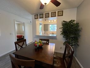 Tucson apartment for rent - a dining room and kitchen with a table and chairs and a plant