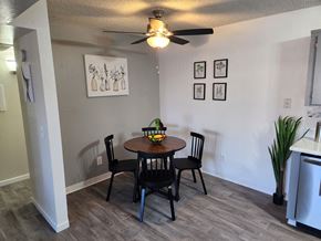 Mesa apartment for rent - a dining area with a table and chairs and a ceiling fan