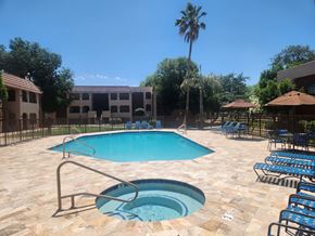 Mesa apartment for rent - a pool with chairs and a spa in a resort pool