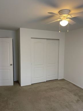 Saint Charles apartment for rent - A room with a ceiling fan and two doors.