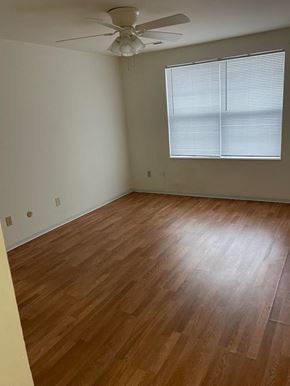 Saint Charles apartment for rent - A room with a ceiling fan and wooden flooring.