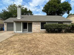 Dallas house for rent - A house with a grey roof and a chimney.
