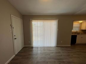 Dallas house for rent - A room with a white door and a window with blinds.