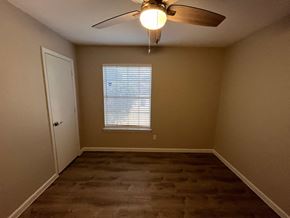 Dallas house for rent - A room with a ceiling fan and a window with blinds.