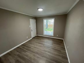 Mesquite house for rent - A room with a wooden floor and a window.