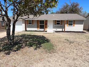 Plano house for rent - a white house with a tree in front of it