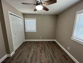 Plano house for rent - an empty bedroom with wooden floors and a ceiling fan