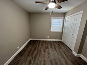 Plano house for rent - an empty room with wooden floors and a ceiling fan
