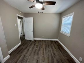 Plano house for rent - a living room with hardwood floors and a ceiling fan