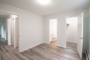 Edmonton apartment for rent - a renovated living room with white walls and wood floors
