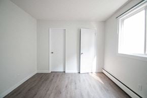Edmonton apartment for rent - an empty room with white walls and wood floors