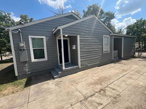 Dallas house for rent - the exterior of a blue house with a driveway and a front door