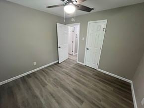 Mesquite house for rent - A room with a ceiling fan and two doors.