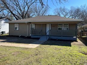 Dallas house for rent - A house with a grey roof and a porch.