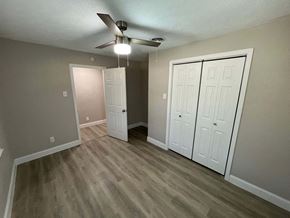 Dallas house for rent - A room with a ceiling fan and two white doors.