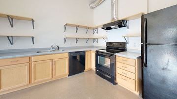 Minneapolis apartment for rent - a kitchen with black appliances and wooden cabinets