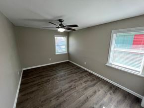 Dallas house for rent - A room with a ceiling fan and a window with blinds.