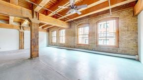 St. Paul apartment for rent - an empty room with a ceiling fan and brick walls