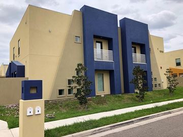 Mcallen apartment for rent - A modern building with blue and beige exterior.