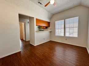 Austin apartment for rent - A room with wooden floors and a ceiling fan.
